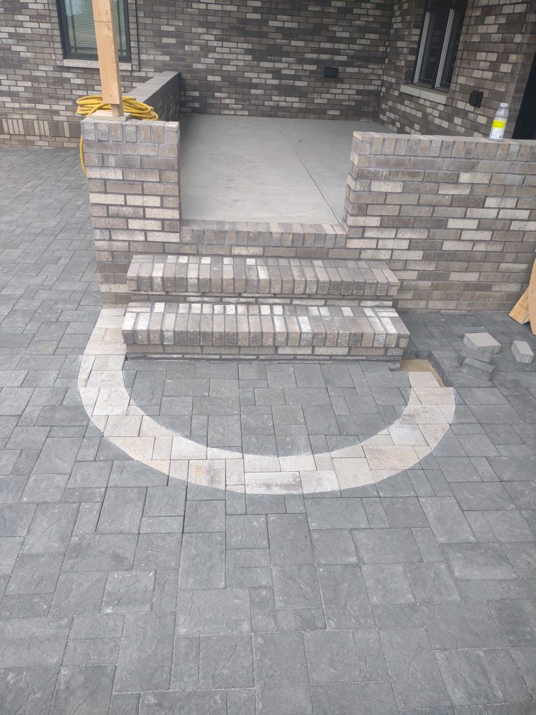 An up close picture of a new patio installation including a stair detail.